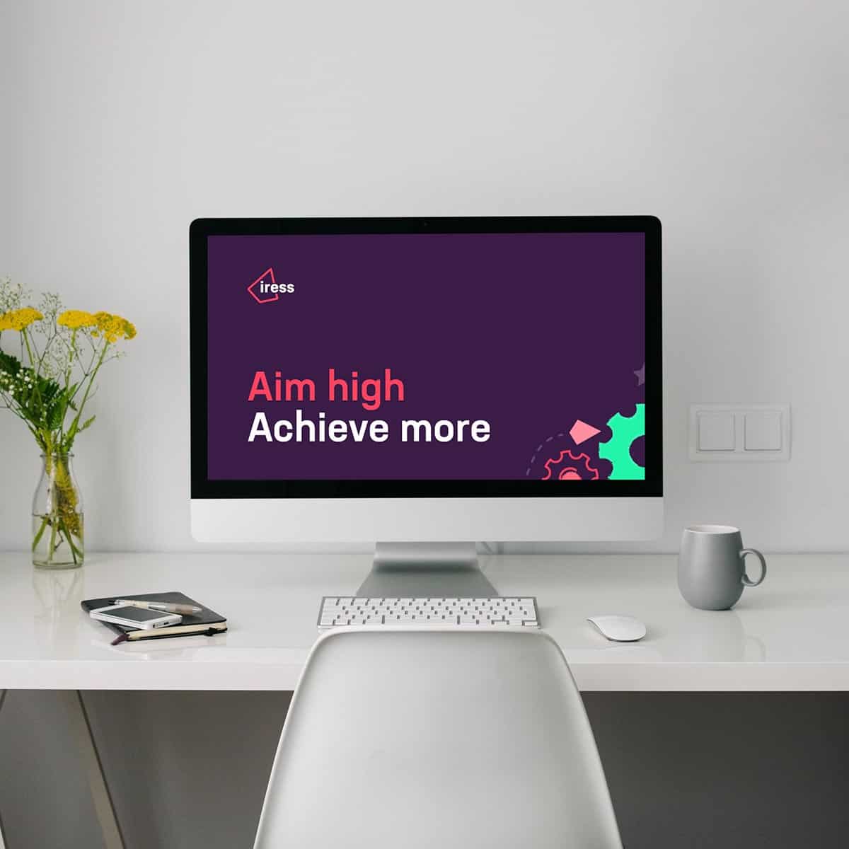 Computer workstation with Iress logo and slogan "Aim high, Achieve more"
